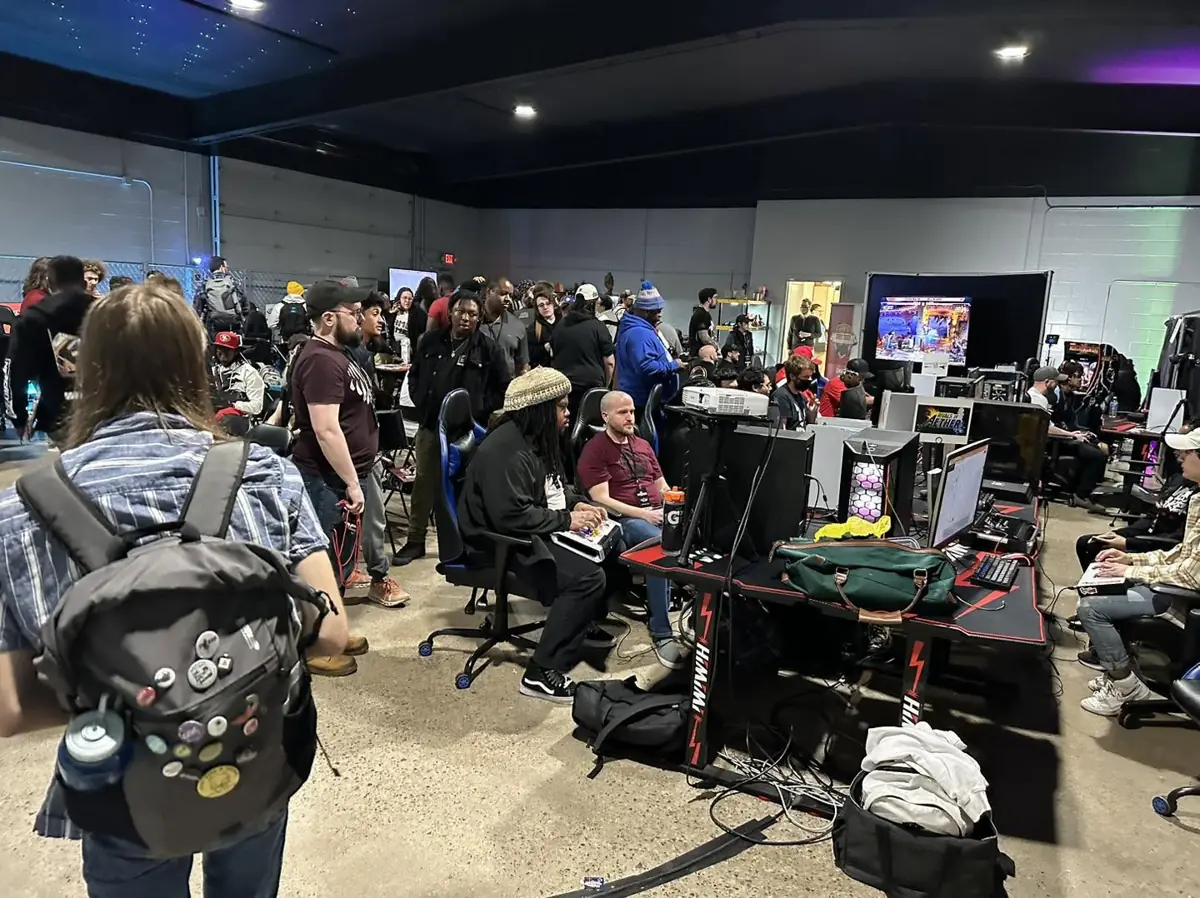 A crowd gathered around gaming stations at Warguts